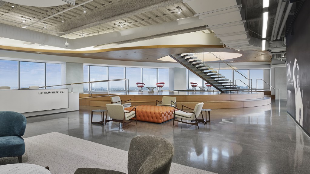 A room with a large table and chairs and a large window.